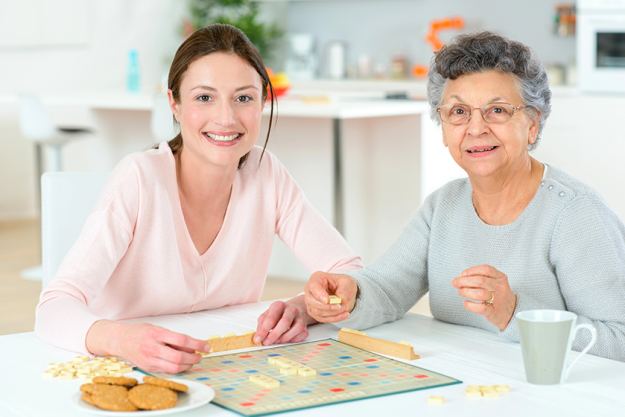 elderly woman playing a board game elderly woman playing a board game
