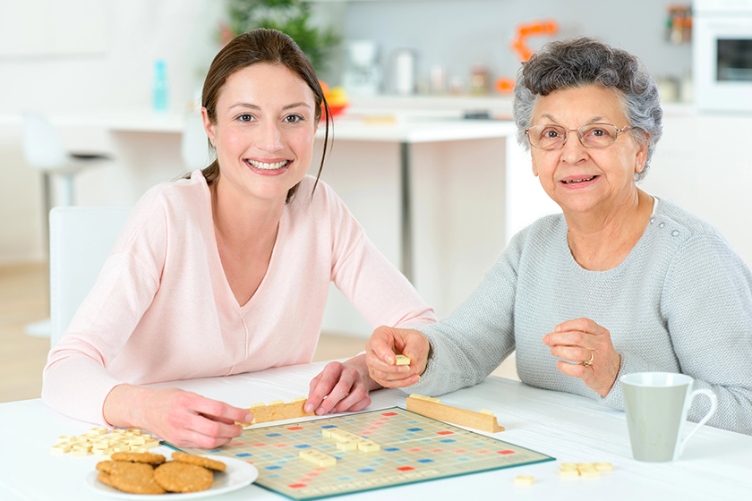 elderly woman playing a board game elderly woman playing a board game