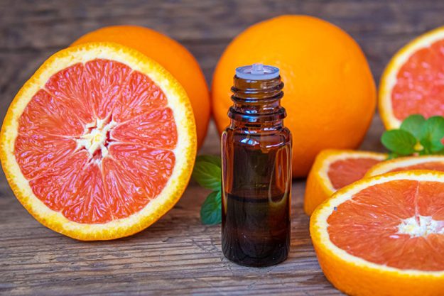 Grapefruit essential oil small bottle selective focus food Grapefruit essential oil small bottle selective focus food
