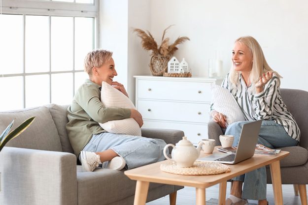 Happy mature women talking home Happy mature women talking home