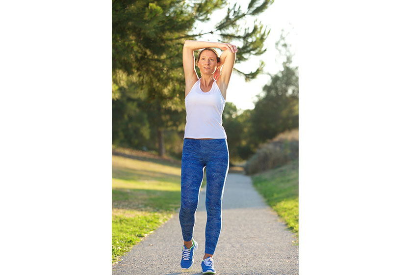 Healthy older woman stretching muscles after workout