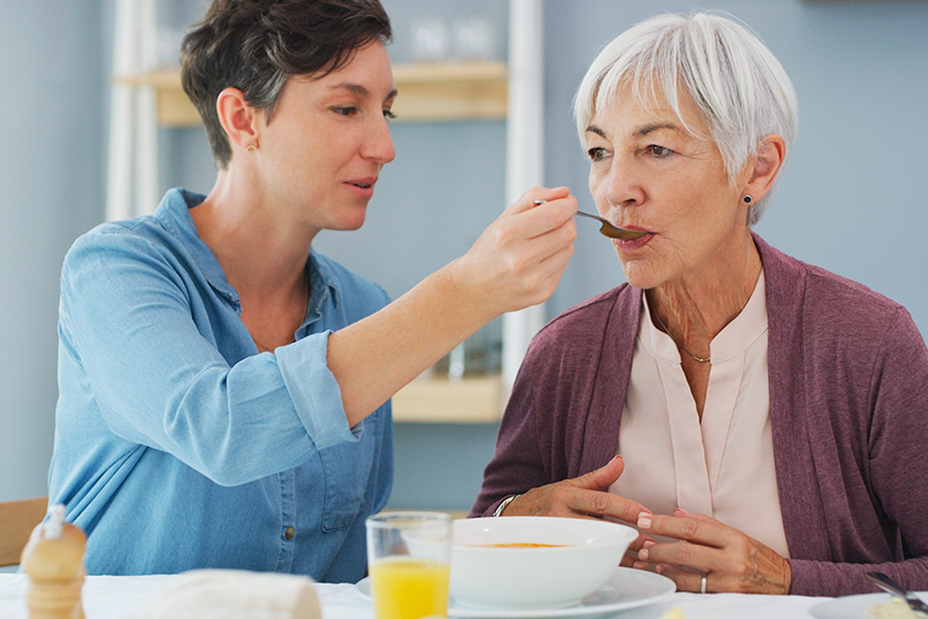 isnt delicious mum attractive young woman helping feeding her senior isnt delicious mum attractive young woman helping feeding her senior