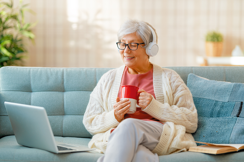 joyful beautiful senior woman using laptop sitting sofa joyful beautiful senior woman using laptop sitting sofa