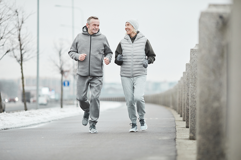 positive mature couple sportswear chatting running