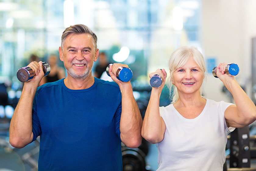 Senior couple exercising in gym