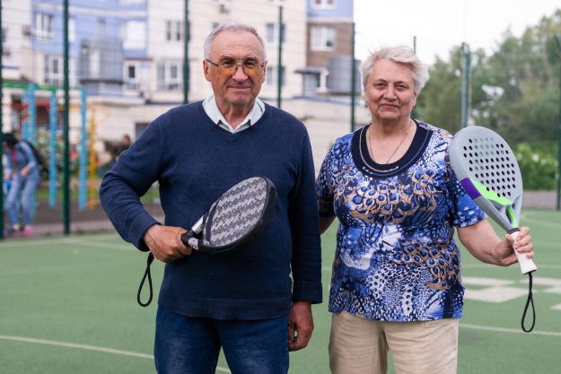 senior man playing paddle tennis a