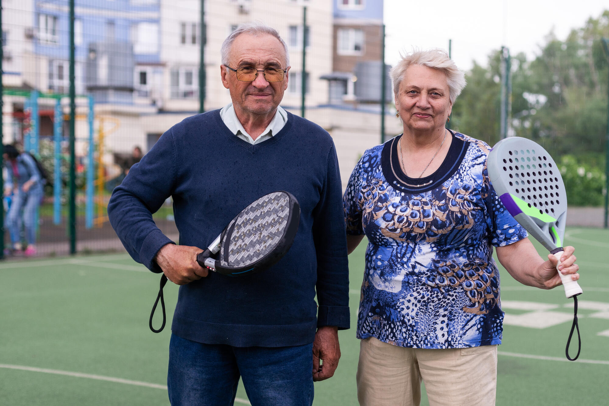 senior man playing paddle tennis a