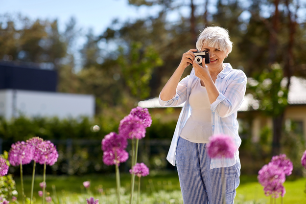 senior woman with camera photographing senior woman with camera photographing