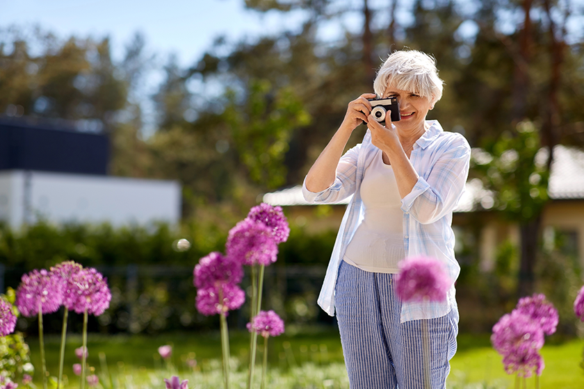 senior woman with camera photographing senior woman with camera photographing