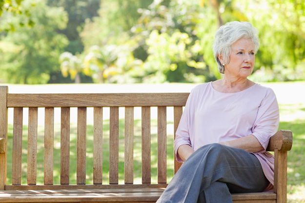 woman looking her side while sitting bench