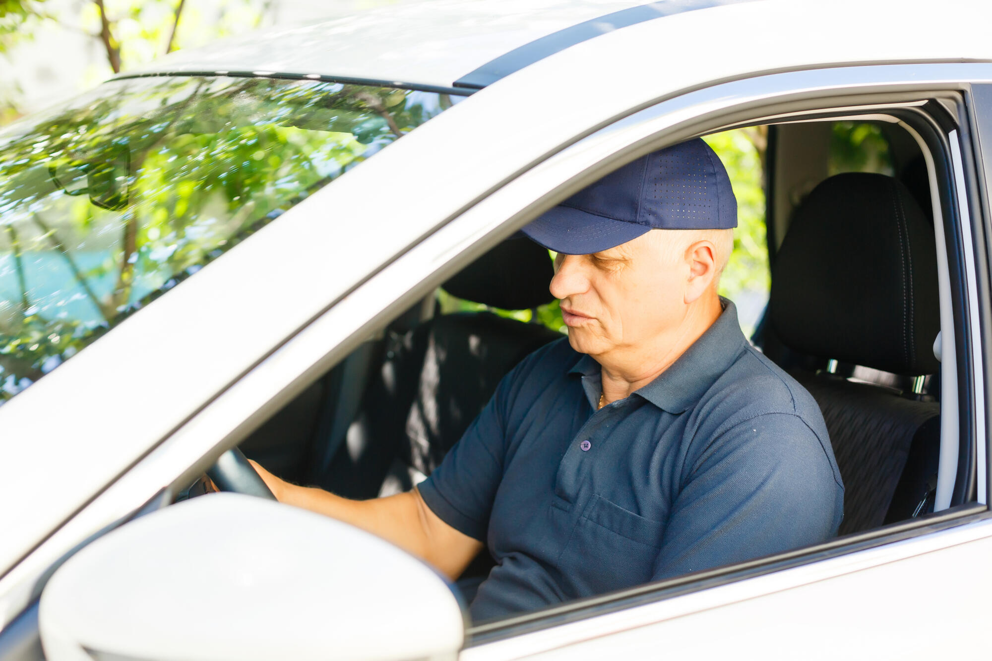Smiling happy elderly senior man in the new car Smiling happy elderly senior man in the new car