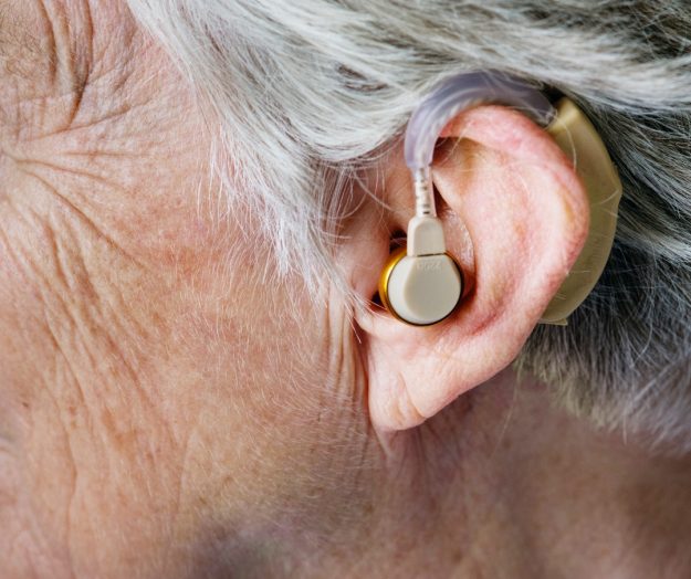 person wearing beige hearing a person wearing beige hearing a