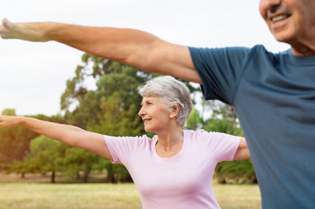 Senior,Woman,Stretching,Arms,At,Park,With,Her,Husband.,Happy