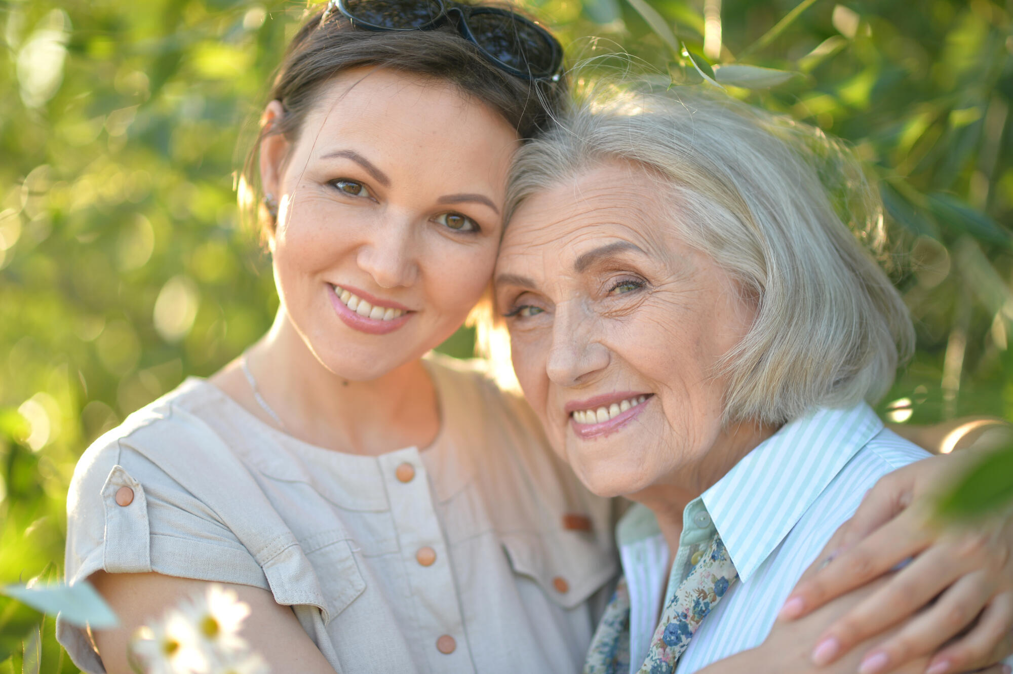 Beautiful elderly woman with her daughter walking in park Beautiful elderly woman with her daughter walking in park