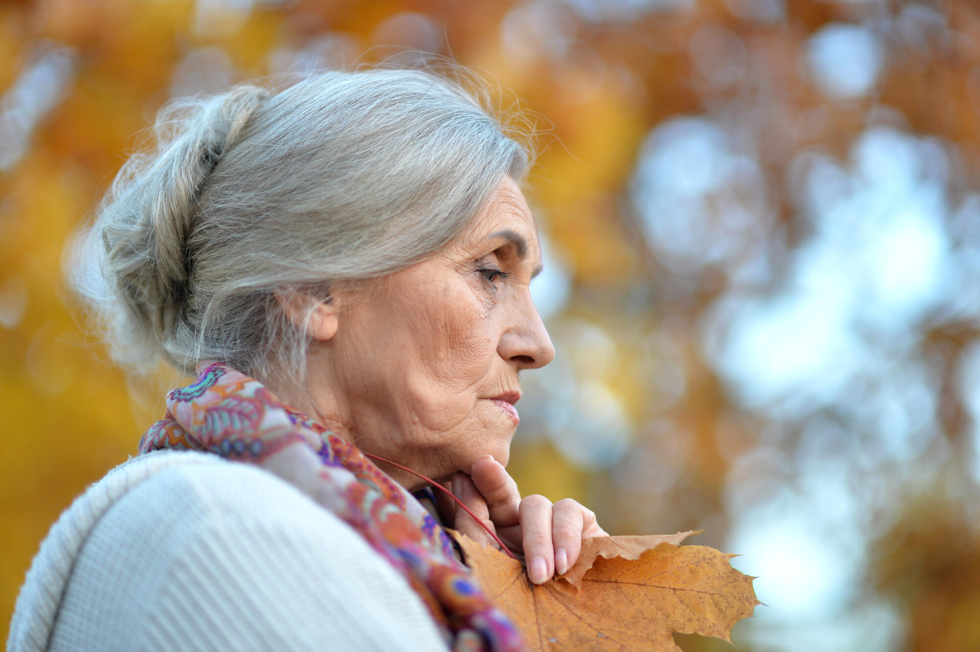 Portrait of beautiful sad senior woman on blurred autumn background Portrait of beautiful sad senior woman on blurred autumn background