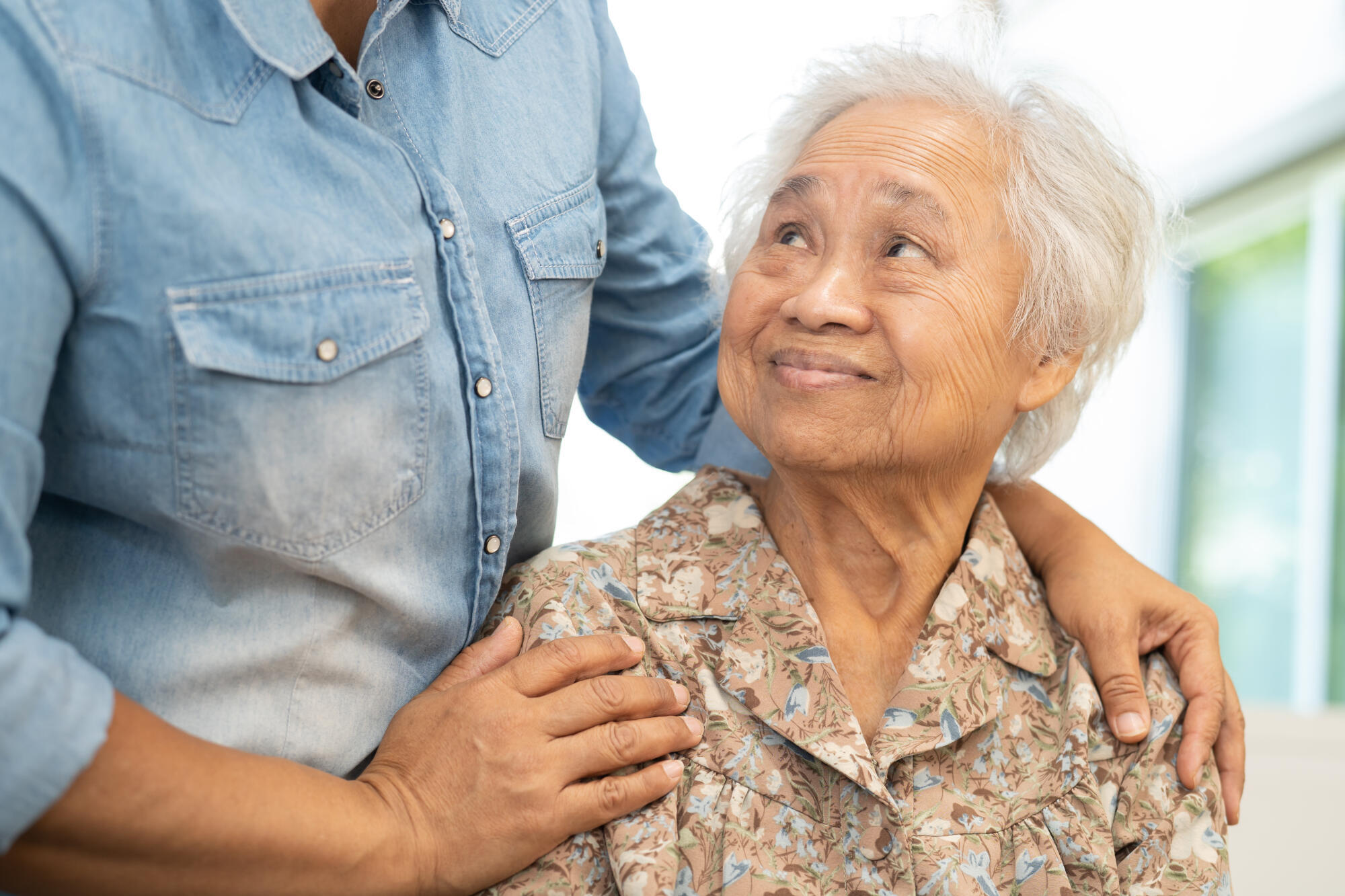 Caregiver help and care Asian senior woman patient with love, en Caregiver help and care Asian senior woman patient with love, en