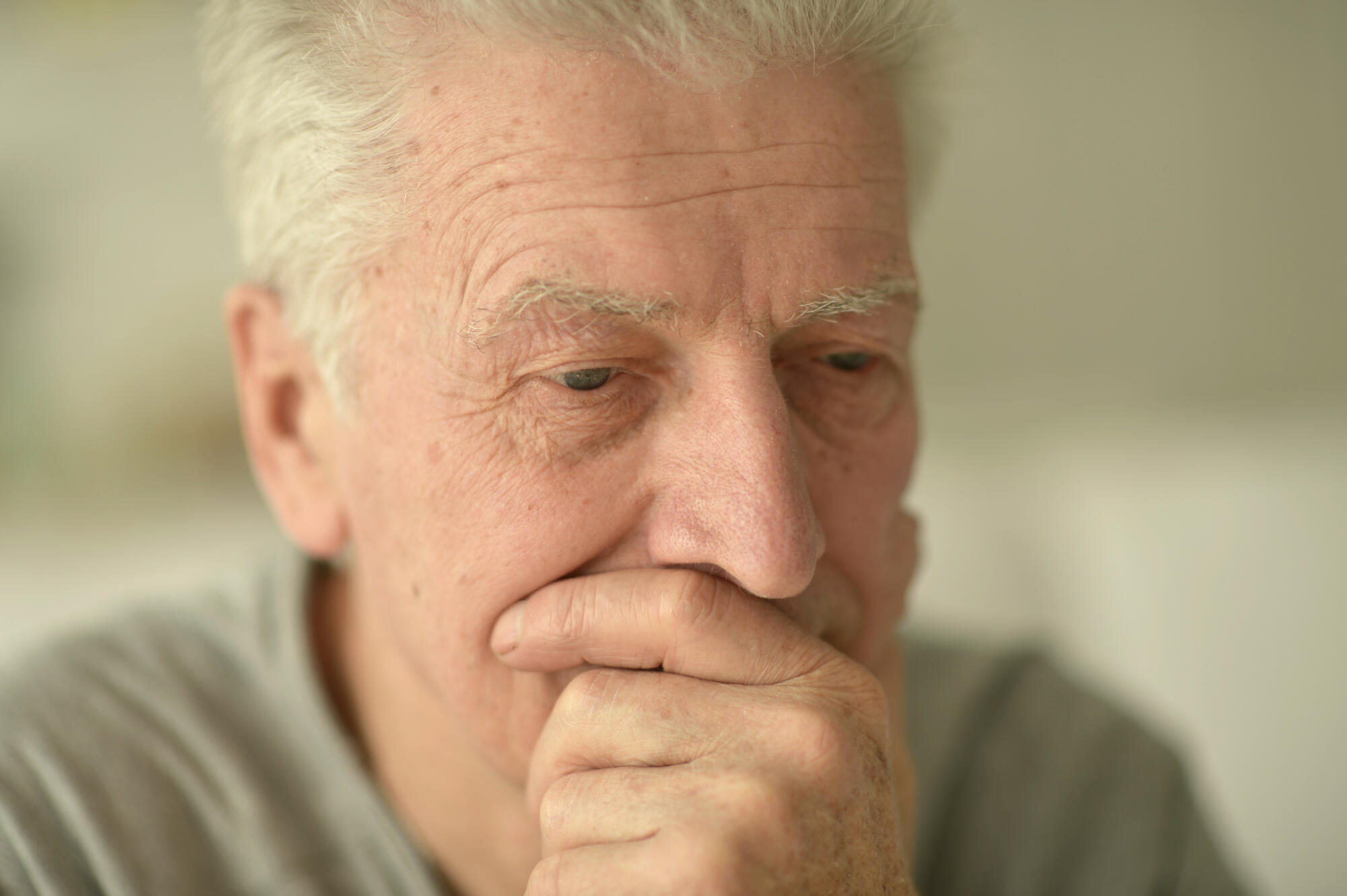 close up portrait of a senior man thinking about something