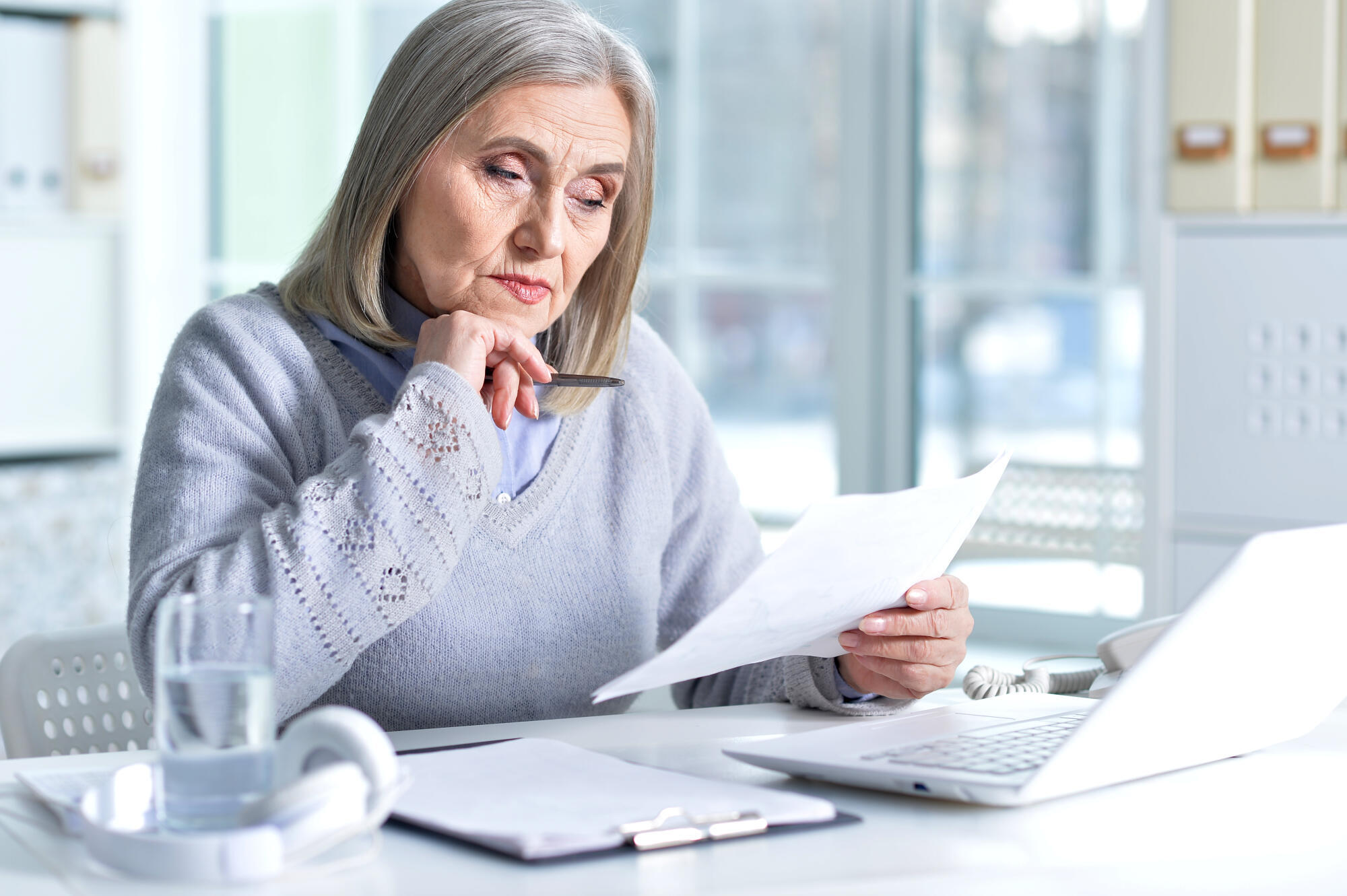Senior business woman working in office with laptop