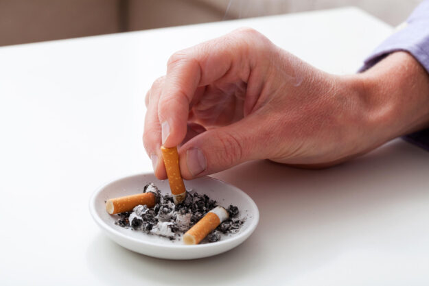 Hand,Putting,The,Cigarette,On,An,Ashtray