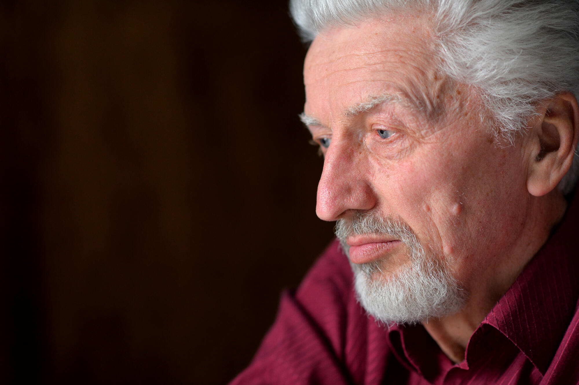 close up portrait of a senior man thinking about something