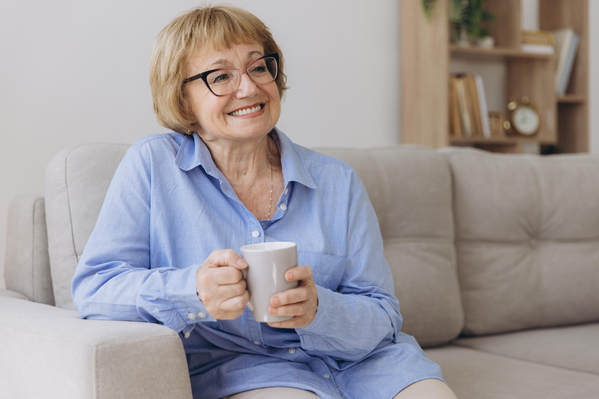 Comfort relaxed senior old elderly woman grandmother drinking ho
