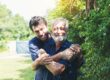 Senior,Father,And,Adult,Son,Hugging,Together,In,The,Garden