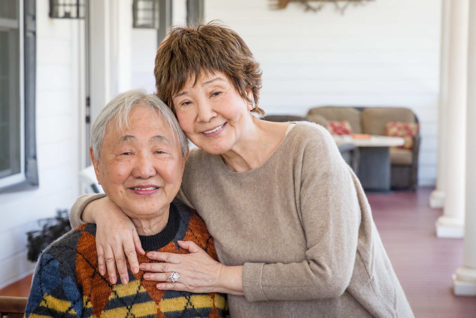 Happy Senior Chinese Couple Pose for Their Portrait On The Porch. Happy Senior Chinese Couple Pose for Their Portrait On The Porch.