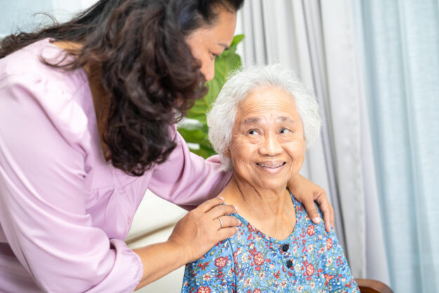 Caregiver help and support Asian senior woman with love and care