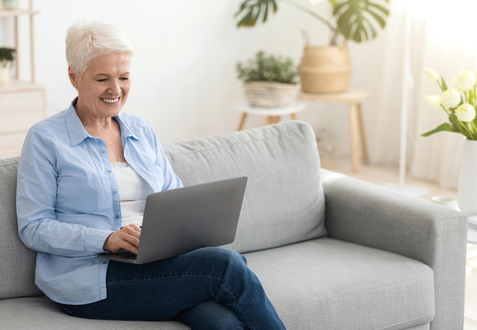 Business After Retirement. Smiling Senior Woman Working On Laptop Computer At Home