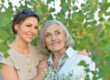 An elderly woman with her daughter in the park in summer