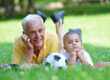 happy grandfather and child in park