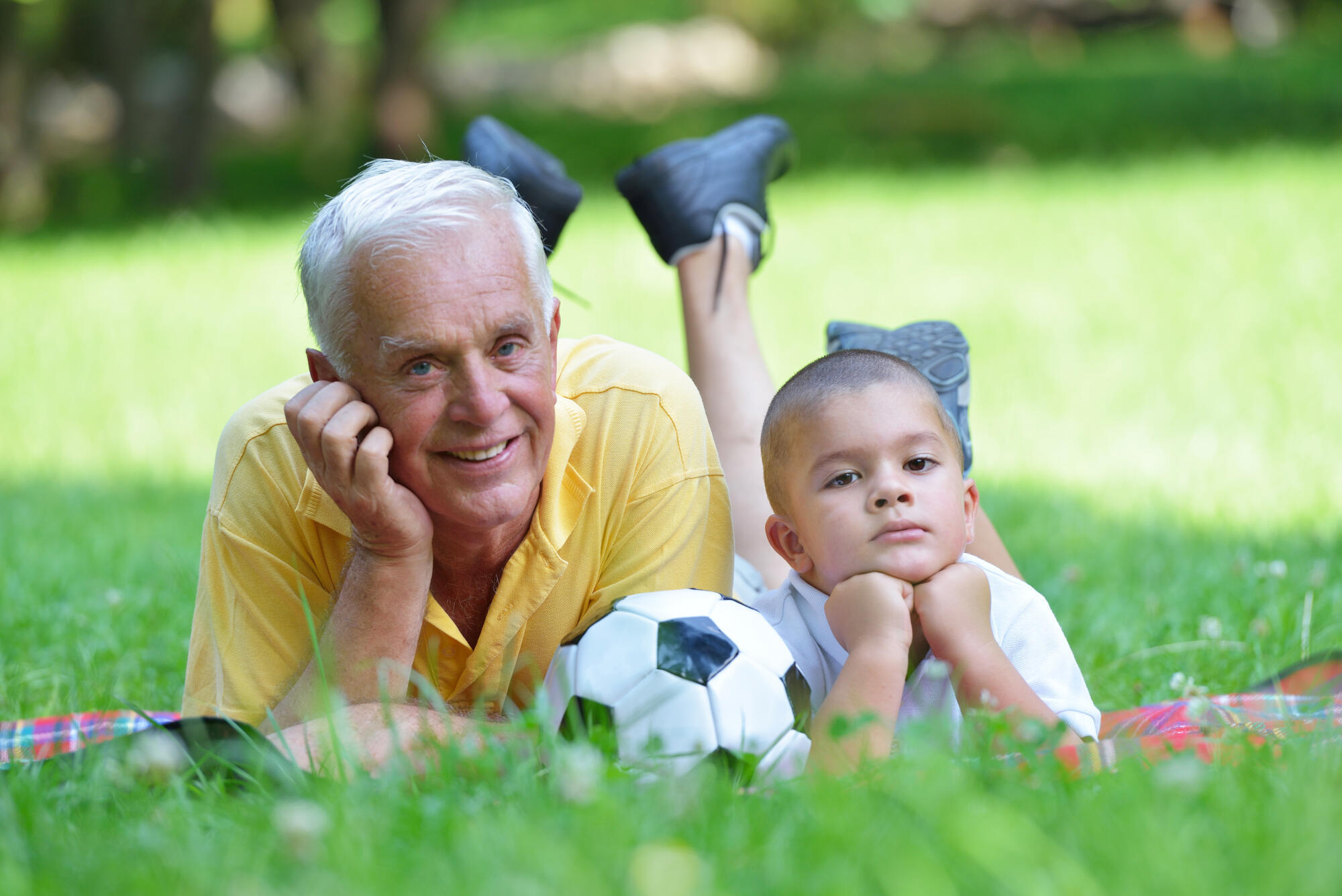 happy grandfather and child in park
