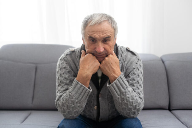 Thinking senior man on a white background