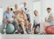 Group,Of,Active,Seniors,Sitting,On,Exercising,Balls,In,Modern