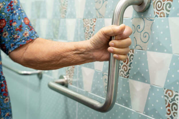 Asian elderly woman use bathroom handle security in toilet, heal