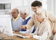 Elder,Lady,With,Glasses,Helping,Her,Friend,With,Computer,Issue