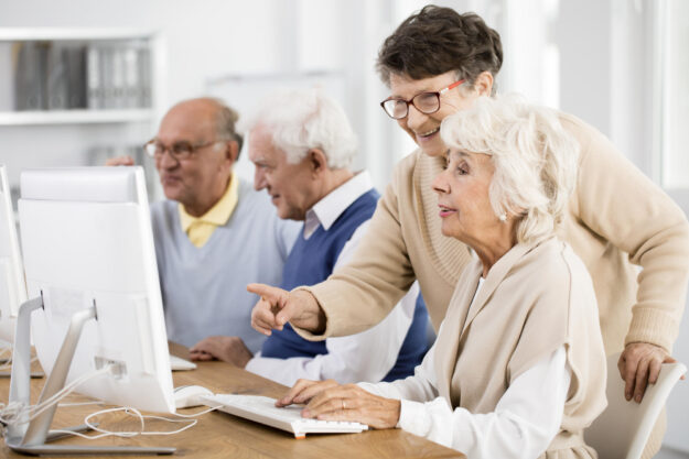 Elder,Lady,With,Glasses,Helping,Her,Friend,With,Computer,Issue Elder,Lady,With,Glasses,Helping,Her,Friend,With,Computer,Issue