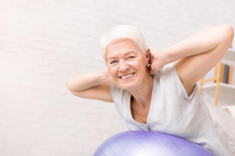 Happy mature woman doing exercises with fitness ball Happy mature woman doing exercises with fitness ball