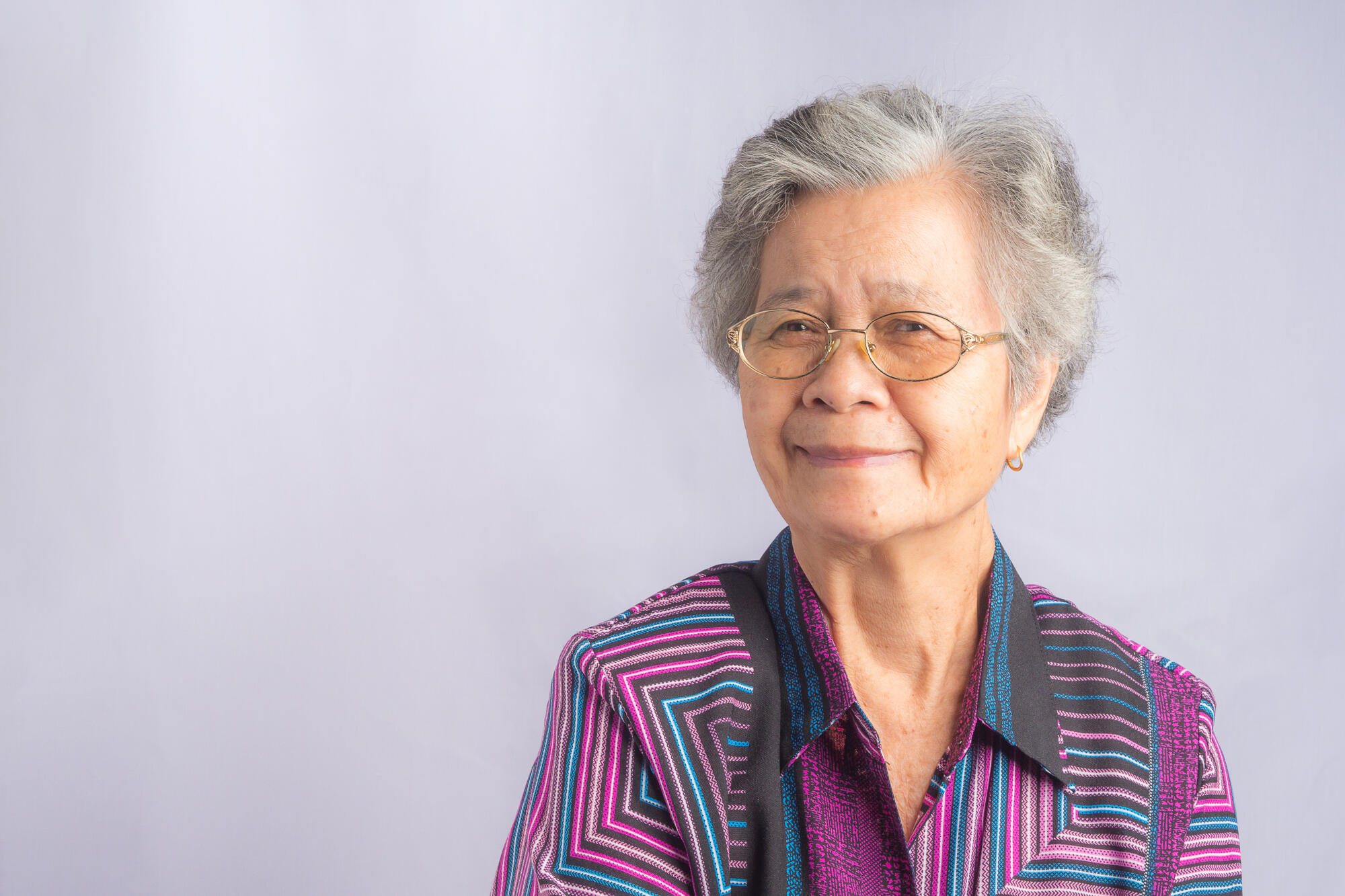 Portrait of a beautiful senior Asian woman wearing glasses with