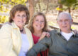 Portrait of Senior Couple with Daughter in the Park.