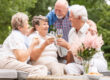 Happy,And,Smiling,Senior,People,Drinking,Wine,On,The,Terrace
