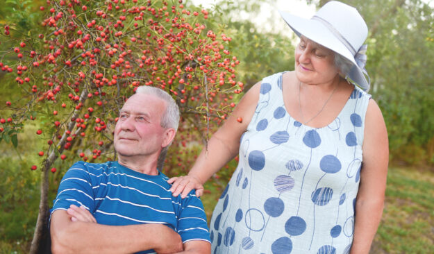 Happy senior couple enjoying each other in the park. Support and care from a loved one. love concept Happy senior couple enjoying each other in the park. Support and care from a loved one. love concept