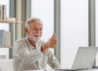 Portrait of senior man using laptop using laptop talking on vide