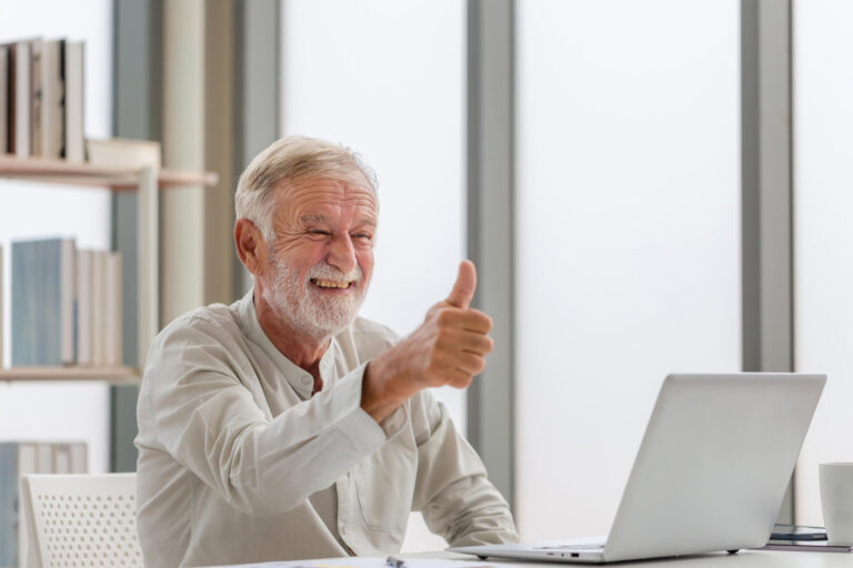Portrait of senior man using laptop using laptop talking on vide Portrait of senior man using laptop using laptop talking on vide