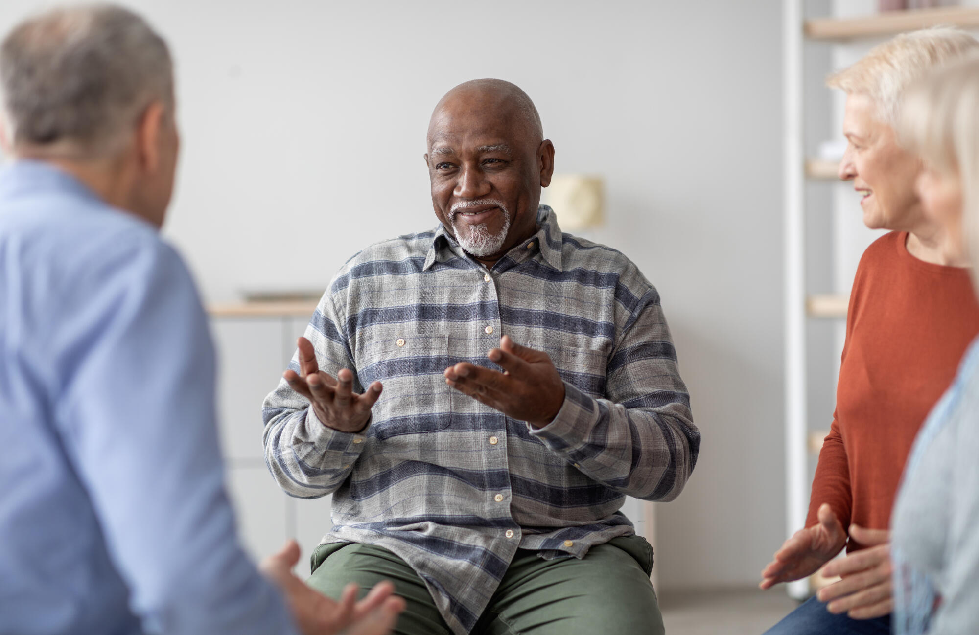 Cheerful african american elderly man having conversation with coach Cheerful african american elderly man having conversation with coach