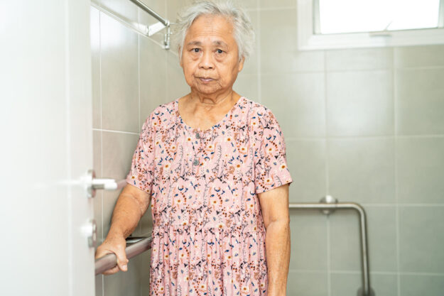 Asian senior or elderly old lady woman patient use toilet bathro
