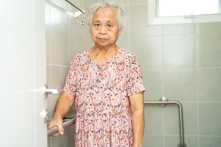 Asian senior or elderly old lady woman patient use toilet bathro