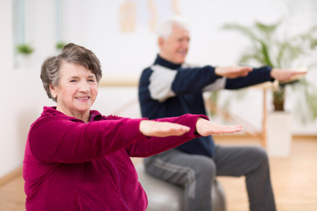 Elderly,Woman,Exercising,During,Pilates,For,Seniors,In,Retirement,Home Elderly,Woman,Exercising,During,Pilates,For,Seniors,In,Retirement,Home