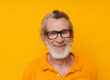 an elderly man with glasses in a yellow t shirt with glasses close up