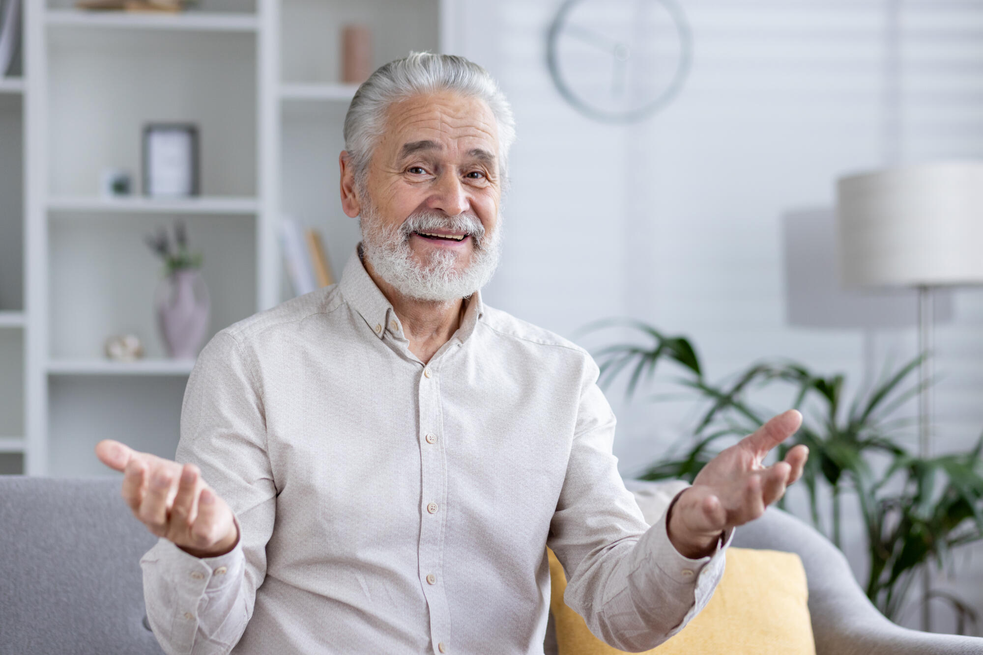 Senior man in video call with a casual expression at home